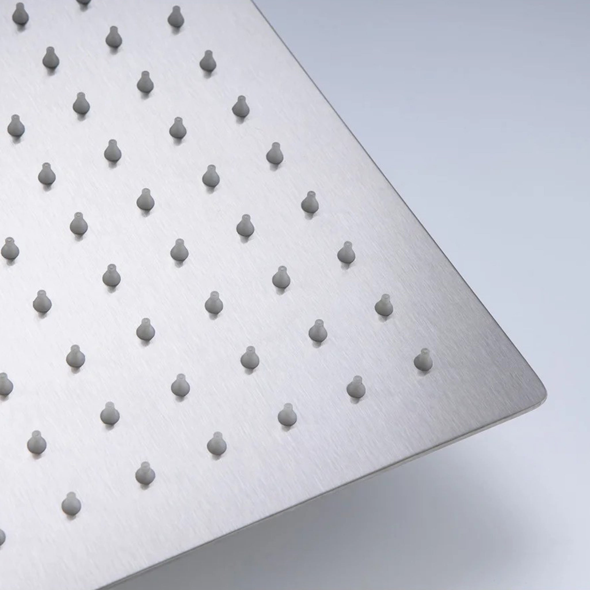 Stainless steel shower head with anti-clog silicone nozzles